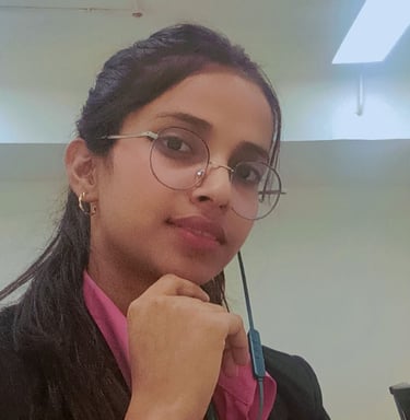 a woman in glasses and a pink shirt