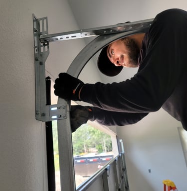 Alejandro repairing a garage door | On Point Overhead Doors - Kyle, TX