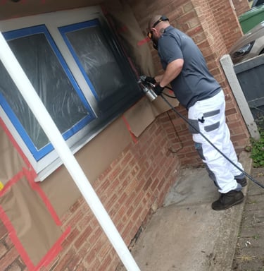 Mr Spray technician applying UPVC spray paint to ground floor windows in Worcester