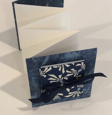 Accordion with Japanese paper and small accordion on cover, ribbon detail