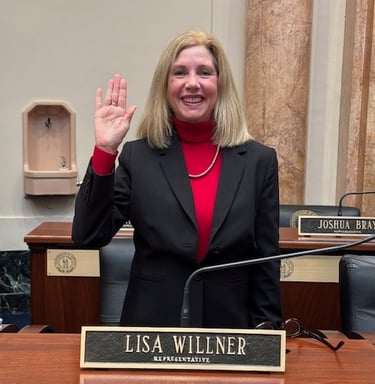 a woman in a suit and red top standing in front of a microphone