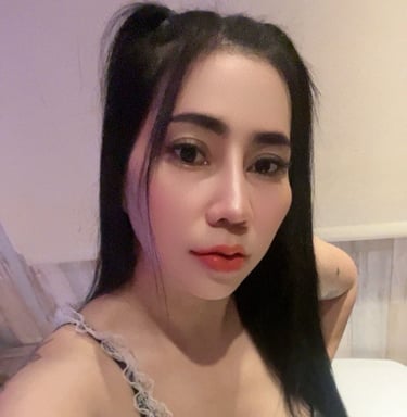 Lady wearing a black and white under garment and poised on her knees