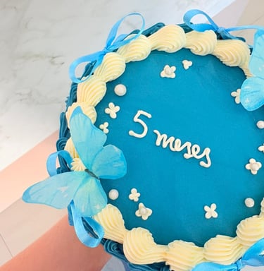a cake with a blue and white cake with a name on it