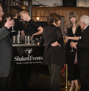 Guests enjoying drinks at a Shaken Events mobile cocktail bar during a professional corporate event