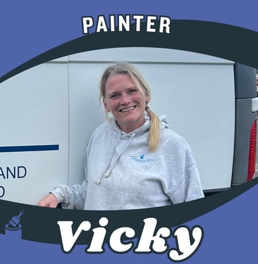 Portrait of Vicky, an LPAD painter, smiling and standing next to her branded van.
