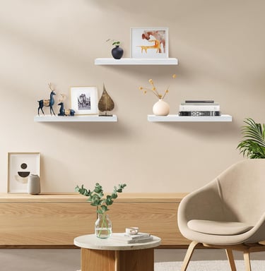 White floating shelves displaying plants, books, and modern home decor accessories