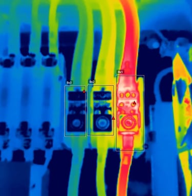 Thermal imaging scan of electrical wires showing a hot circuit breaker hotspot.