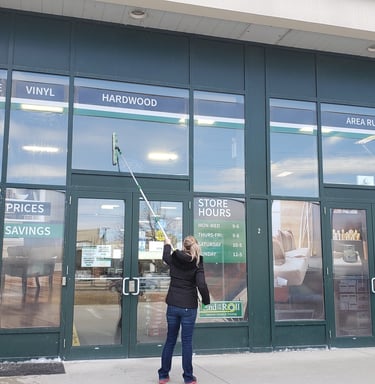 a woman window cleaning a store bantford ontario