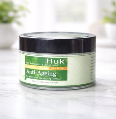 A jar of Huk Anti-Ageing Herbal Cream with hyaluronic acid on a white marble surface.