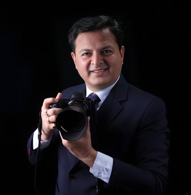a man in a suit and tie is holding a camera