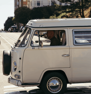 A van in Surrey, BC, with a dog sitting in the driver's seat of a van
