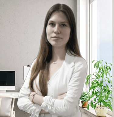 a woman in a white shirt and jeans standing in front of a computer