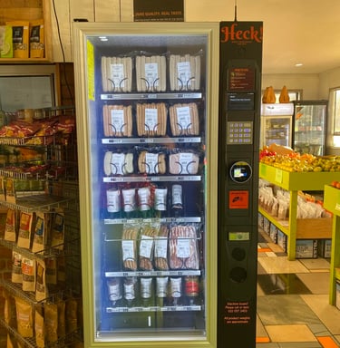 Commercial refrigerated vending machine stocked with snacks and beverages in Australia.