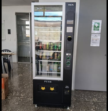 Commercial snack and drink vending machine installed at an Australian retail location.