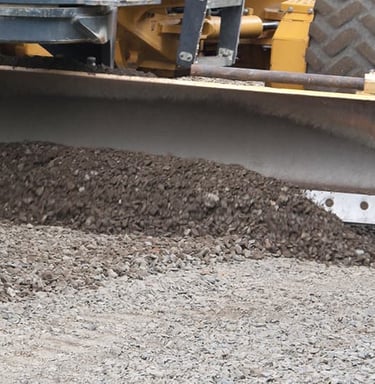 bobcat grading gravel driveway