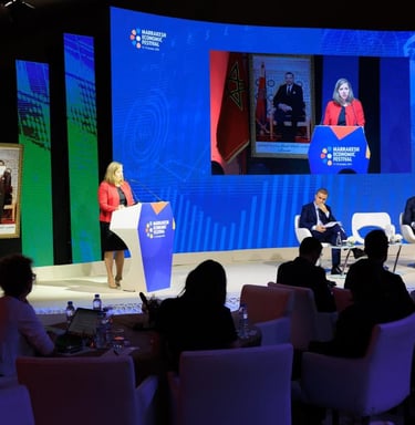 a group of people sitting at a podium with a speaker
