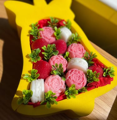 a custom gift box in shape of a bell filled with flowers and treats