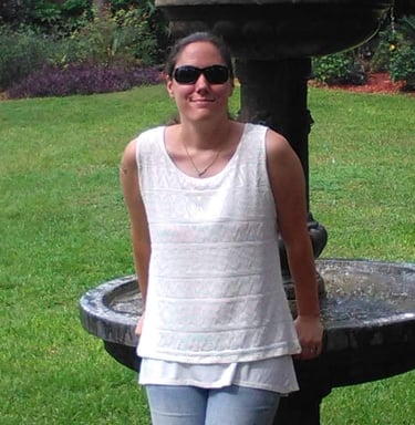 a woman standing in front of a fountain