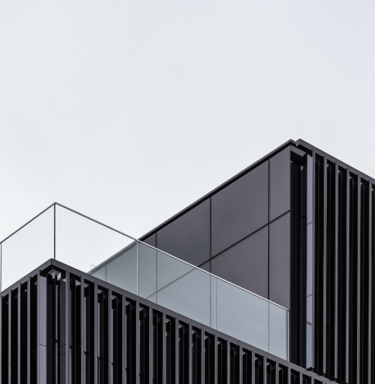 a building with a clock towering over a balcony