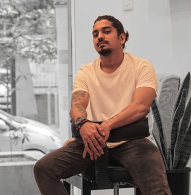 Photo of a Tattoo Artist posing on a chair