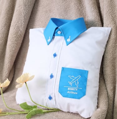 a white pillow designed as shirt with blue collar and pocket
