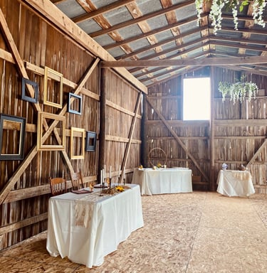 a barn wedding reception tables with table cloths