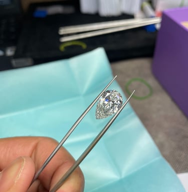A person holding a polished lab grown diamond