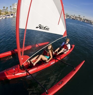 a woman and a man on a sailboat