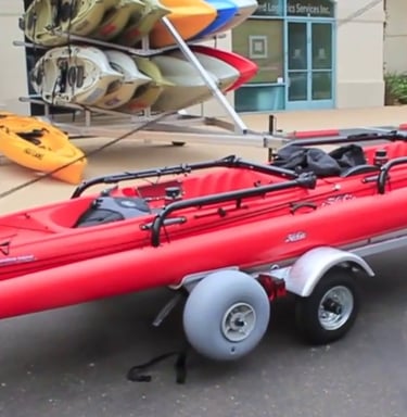 a red kayak on a trailer