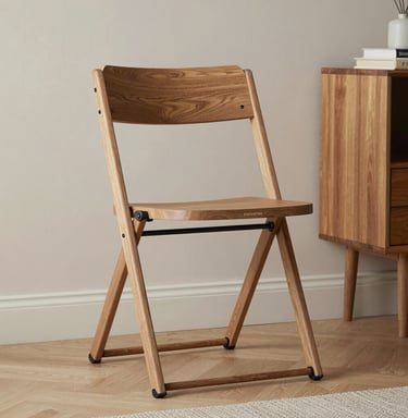 A sleek foldable bed neatly tucked against a wall in a bright, minimalist apartment.