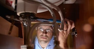 Plumber Inspecting Drain