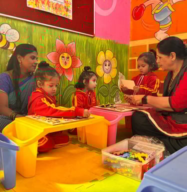 Preschool students in red uniforms solve educational puzzles with teachers in a colorful play school classroom.