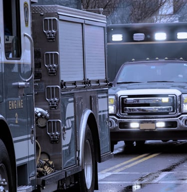 "Fire engine truck and emergency response vehicles on street during call"