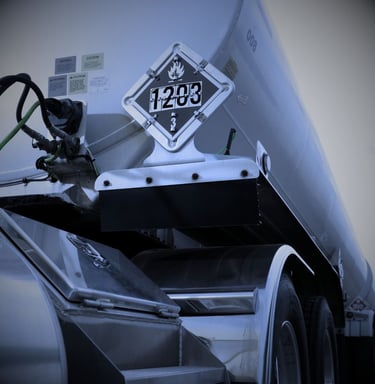 "DOT hazmat truck with 1203 gasoline placard for flammable liquid transportation"