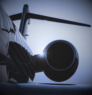 "Private jet engine and aircraft wing with dramatic sky and sunlight"