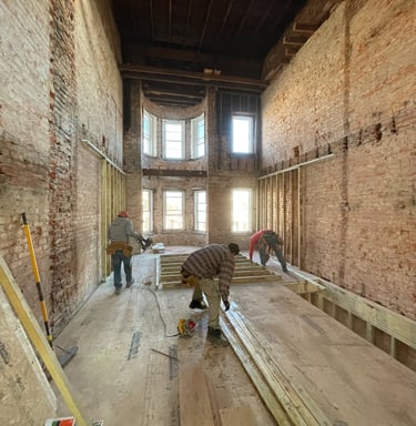 a man is working on a wooden floor