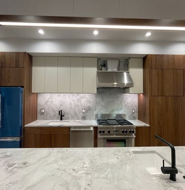 a kitchen with a marble counter top and a blue refrigerator