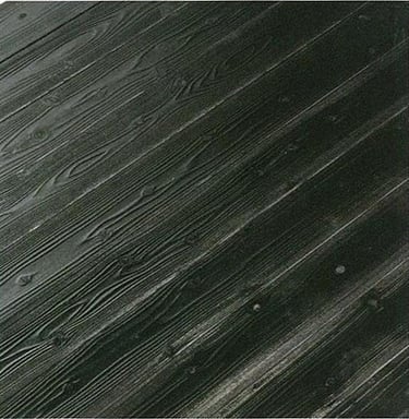 Dark charcoal gray wood grain texture on diagonal siding boards with visible knots.