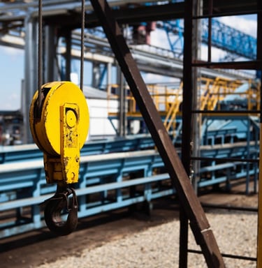 overhead crane hook, production plant in background
