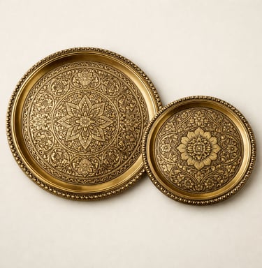 Handcrafted engraved brass serving trays with floral and Mughal motif detailing.