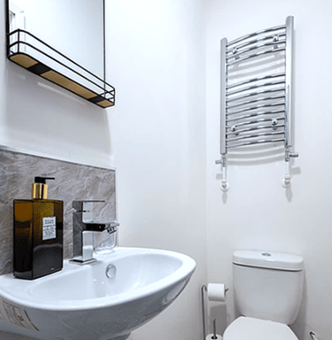 En-suite bathroom with shower, towel radiator and complimentary toiletries