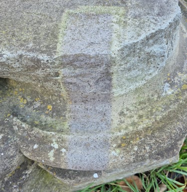 Basalt stone buiding detail partially cleaned with laser cleaner