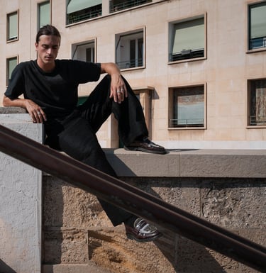 a man sitting on a ledge  in Marseille
