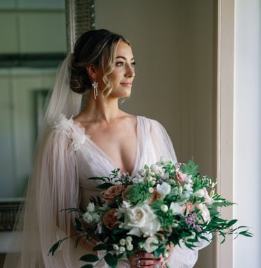 a bride in a wedding dress holding a bouquet