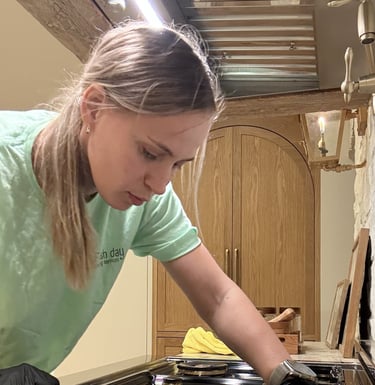 A professional cleaner expertly cleans the cooktop