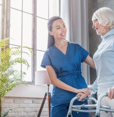 Physical therapy: performing gait training with a geriatric patient at home.
