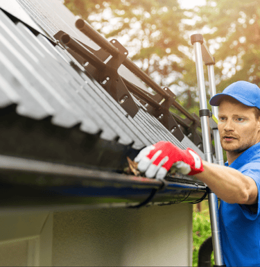 a man in a blue shirt and gloves is holding a pole with a pole with