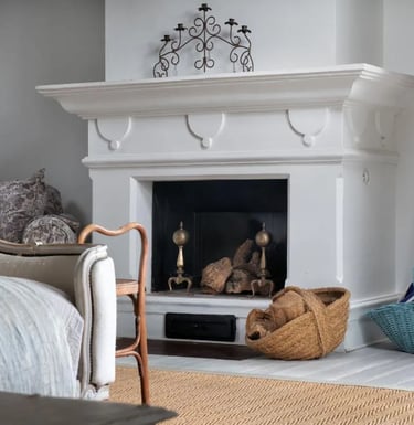 Fireplace with baskets and decor at Finca Santa Katerina