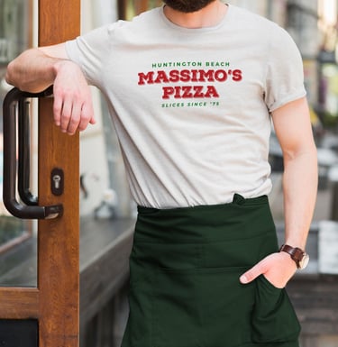 Massimo’s Pizza rebrand logo on staff t-shirt and green apron.