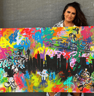 Kamile with her graffiti character painting